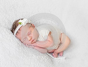 Baby with white hairband, dressed in suit