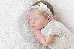 Baby with white hairband, dressed in suit