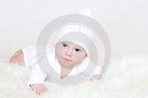 Baby in a white knitted hat