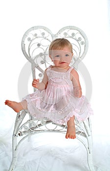 Baby in White Wicker Chair