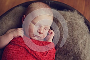 Baby in a wood bowl