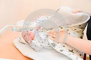 Baby wrapped in a blanket. Sleeping Cute Newborn Infant Wrapped in Baby Blanket in Acrylic Hospital Bassinet just after Birth