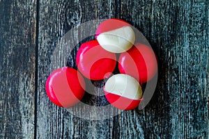 Babybel Cheese in Red Wex on Wooden Surface Ready to Eat