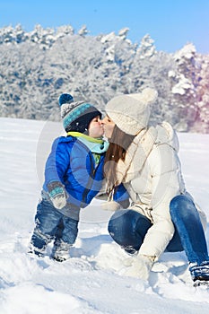 Babyboy son and mother are happy together - winter day