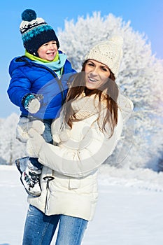 Babyboy son and mother are happy together - winter day