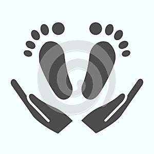 Babys feet in hands solid icon. Mom holds kids feet vector illustration isolated on white. Baby care glyph style design