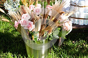 Babyshower bucket with flowers bouquet and diapers