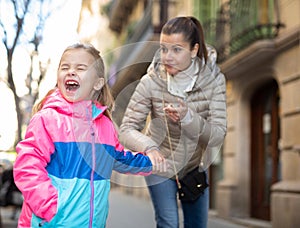 Babysitter comforting crying girl outdoor