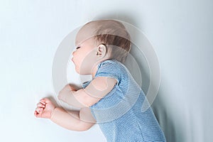 Babysleeps on bed. Infant development concept, toddler restful sleep, teething, colic....