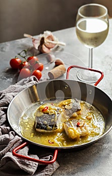 bacalao al pil pil, salted cod in emulsified olive oil sauce, spanish cuisine photo