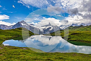 Bachalpsee lake at dawn, Bernese Oberland, Switzerland. Alpine view of the Mt. Schreckhorn and Wetterhorn. Location Bachalpsee in