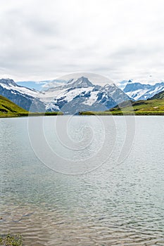 Bachalpsee lake with Schreckhorn and Wetterhorn at Grindelwald in Switzerland