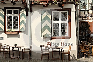 Bacharach, Germany: An  half timbered house with tables and chairs in the garden