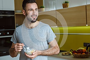 Bachelor man daily routine in a kitchen single lifestyle concept muesli bowl