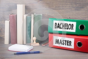 Bachelor and Master. Binders on desk in the office. Business background