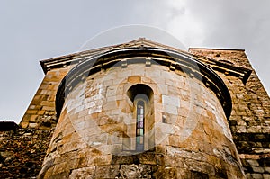 Back apse of an old church Valdibure seen from below during thunderstorm