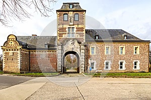 Back arched entrance to Alden Biesen castle, middle tower between brick walls and gable roof