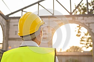 Back of Asian Engineering man looking to construction analyzing about project plan