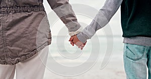 Back, beach and a parent holding hands with a kid while standing outdoor on sand by the coast. Family, children and