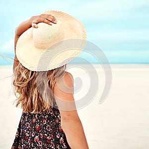 Back, beach and woman with vacation, nature and relaxing with getaway trip and sunshine. Ibiza, rear view and girl with