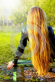 Back of blonde woman with natural long hair