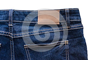 Back of blue jeans with leather jeans label sewed on blue jeans.