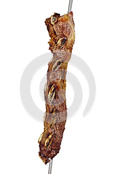 Back bovine beef ribs, traditional brazilian barbecue on skewer on white background.
