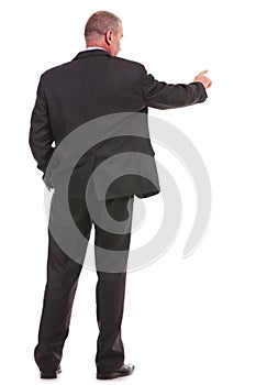 Back of a business man pushing a button