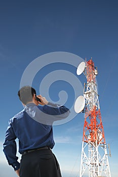 Back of businessman on phone and antenna