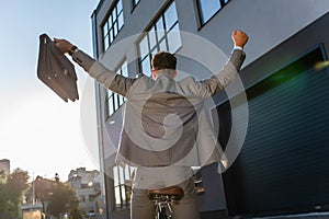 Back of businessman showing yeah gesture