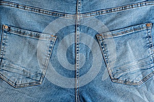 Back of classic jeans. Denim fabric. Yoke, back Pockets