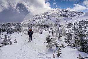 Back country skier on mountain summit