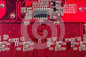 Back side of old red computer motherboard for background.