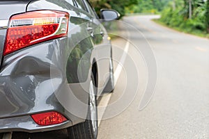 Back of gray car get damaged from accident on the road. Vehicle bumper dent broken by car crash. Road accidents and car insurance photo