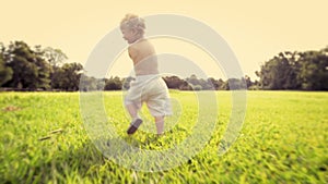 Back, growth and baby boy running on grass in excitement for adventure, discovery or to explore nature. Kids, summer and