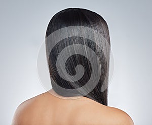 Back, hair care and woman with beauty, shine and wellness with dermatology on white studio background. Rear view, person