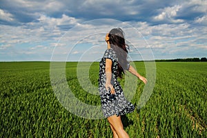 Happy Asian Woman Dancing In Green Field.