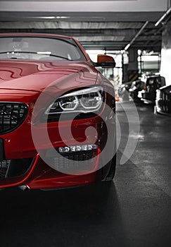 Back headlight of a modern luxury red car, auto detail, car care concept in the garage photo