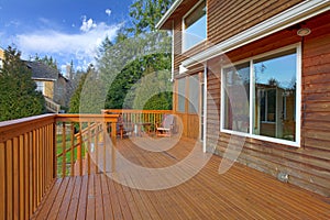Back of the house with a wooden deck photo