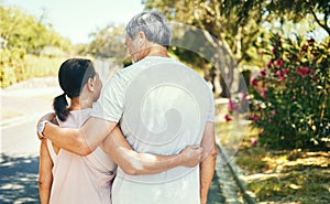 Back, hug and a senior couple on a walk for bonding, love and exercise in the morning. Happy, relax and an elderly man