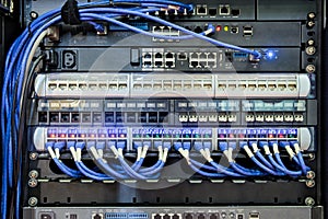 Back I/O port of server rack and blue cable connected to LAN port