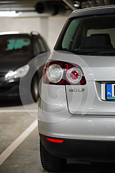 Back lamp of a parked silver colored Volkswagen Golf Plus in a parking