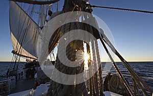 Back light of the sunrise on a sailing boat
