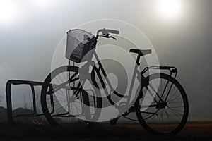 Back lit silhouette of bike in bicycle stand