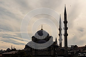 Back lit view of historical mosque called Yeni in Eminonu