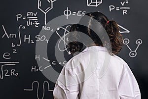 Back of a little girl science student in lab coat