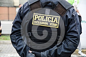 Back of a male police officer, uniform of a policeman in Peru, on his back says police squadron green