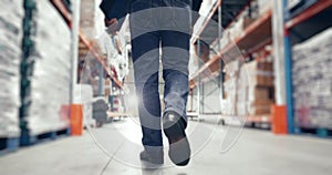 Back, man and walking in warehouse for storage, distribution and wholesale production. Closeup, factory worker and