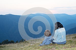 Back of mother and son in the mountains