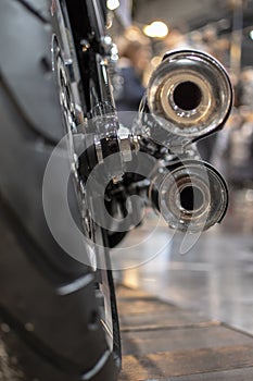 The back of the motorcycle, the wheel and exhaust pipe, chromed and the speeder`s wheel